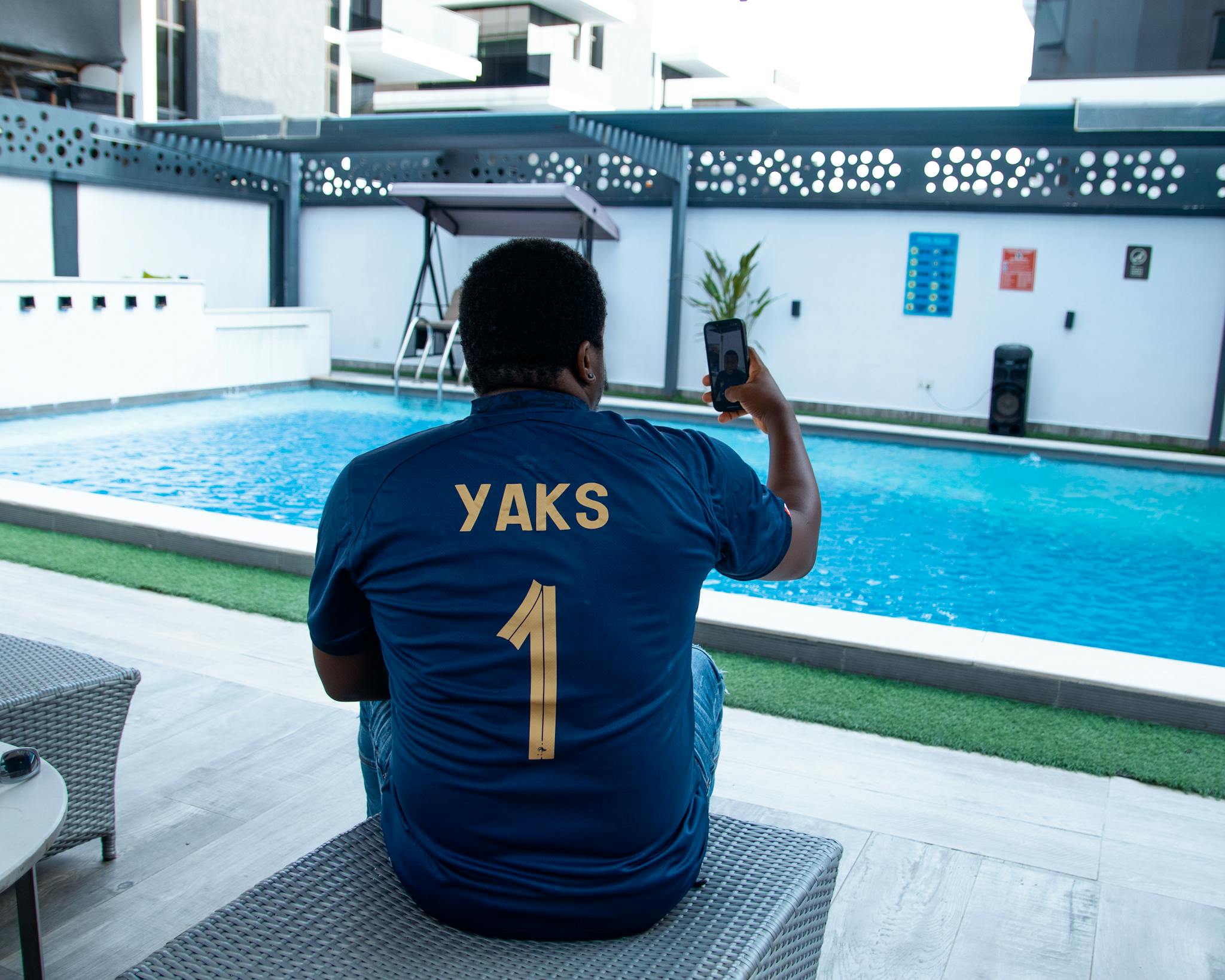 Man Taking a Selfie near the Pool